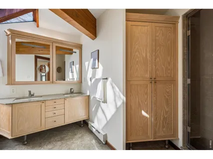 a bathroom with a double vanity sink and a mirror