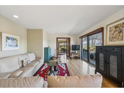 a living room with furniture large window and flat screen tv