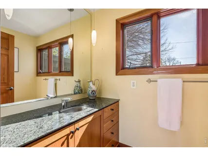 a bathroom with a granite countertop sink mirror and a