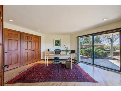 a living room with furniture rug and wooden floor