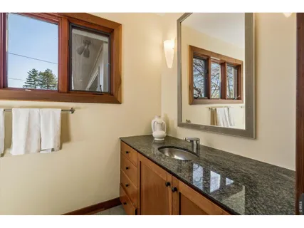a bathroom with a sink a mirror and a window