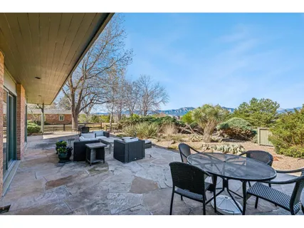 a view of a patio with table and chairs and potted plants