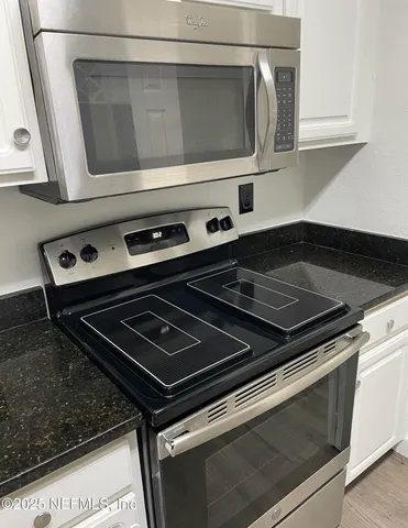 a stove top oven sitting inside of a kitchen