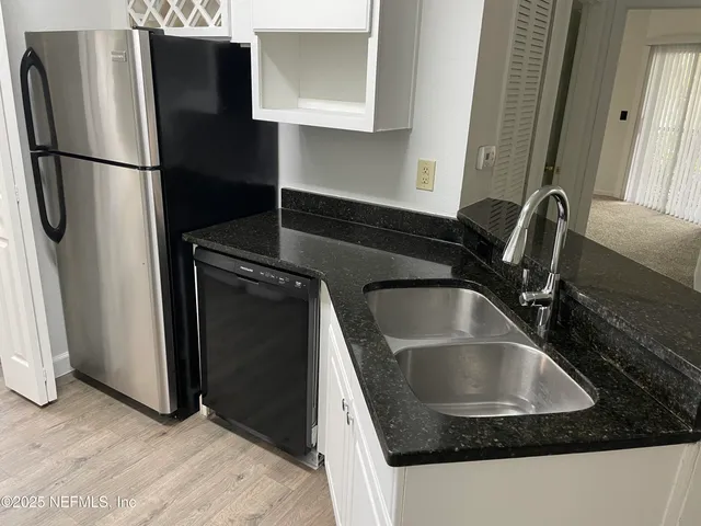 a kitchen with a sink a stove and cabinets