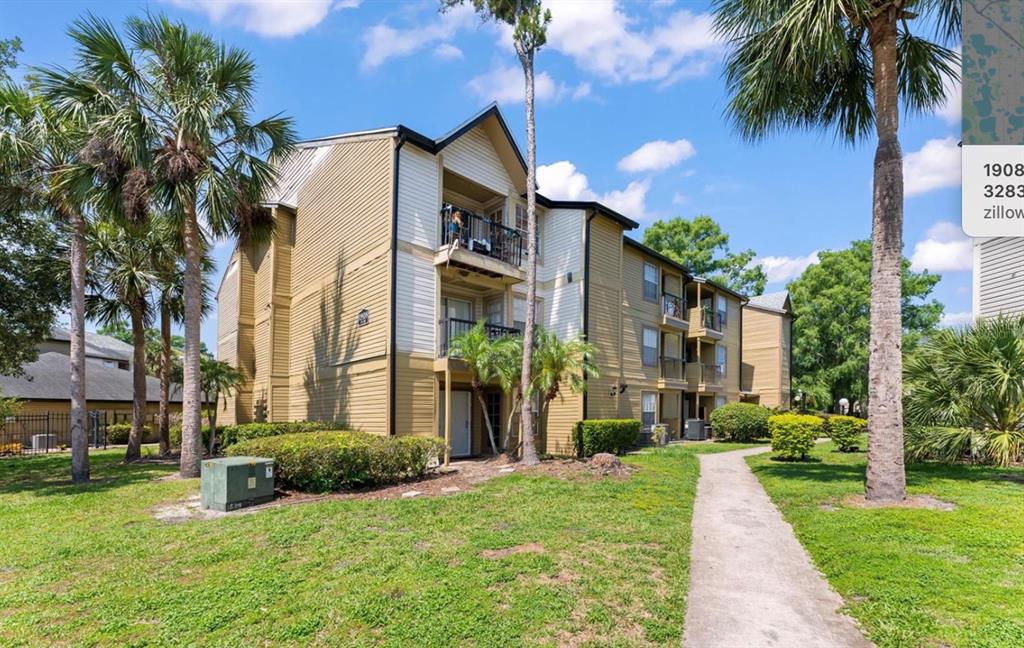 1908 Lake Atriums Circle, Unit 3 Orlando, FL 32839 - Photo 1 of 17 a view of a house with a yard and plants