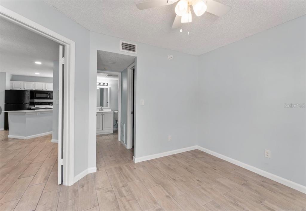1908 Lake Atriums Circle, Unit 3 Orlando, FL 32839 - Photo 12 of 17 wooden floor in an empty room with a kitchen