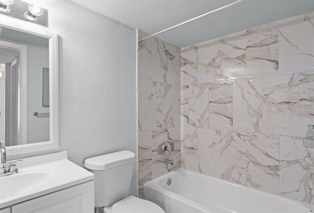 1908 Lake Atriums Circle, Unit 3 Orlando, FL 32839 - Photo 14 of 17 a bathroom with a sink toilet and shower