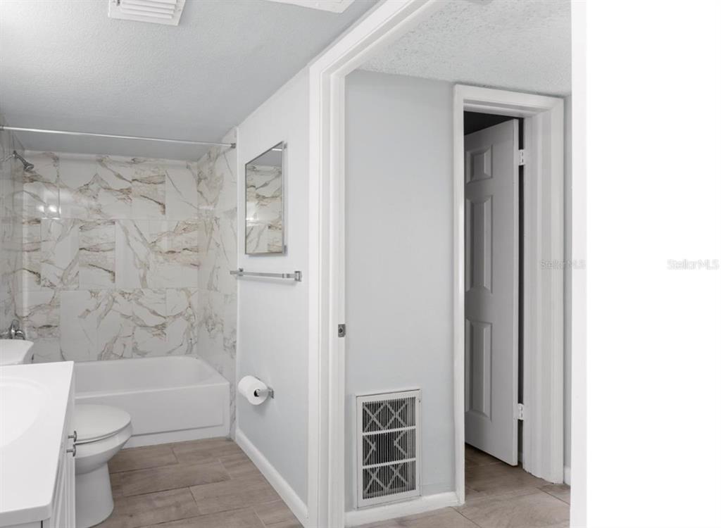 1908 Lake Atriums Circle, Unit 3 Orlando, FL 32839 - Photo 15 of 17 a bathroom with a toilet a sink and bathtub