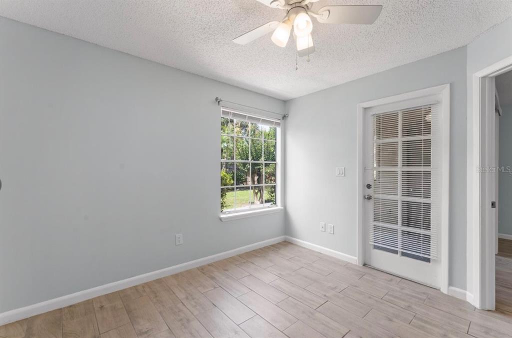 1908 Lake Atriums Circle, Unit 3 Orlando, FL 32839 - Photo 3 of 17 an empty room with windows and chandelier fan
