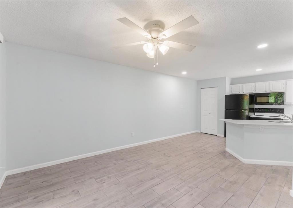 1908 Lake Atriums Circle, Unit 3 Orlando, FL 32839 - Photo 6 of 17 a view of an empty room with a kitchen
