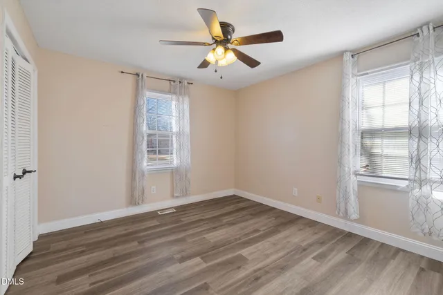 wooden floor in an empty room with a window