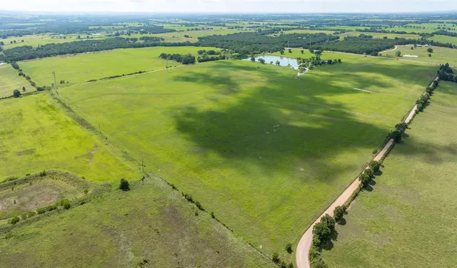 an aerial view of ocean with residential houses with outdoor space