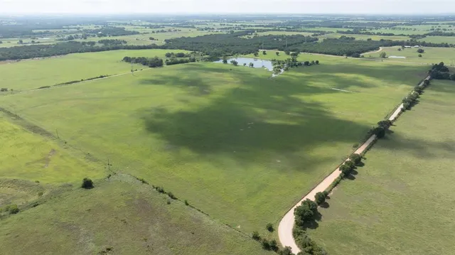 an aerial view of ocean with residential houses with outdoor space