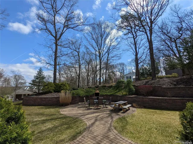 a view of swimming pool with lawn chairs and plants
