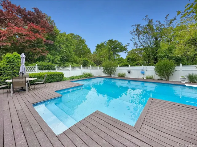 a view of a wooden deck with chairs