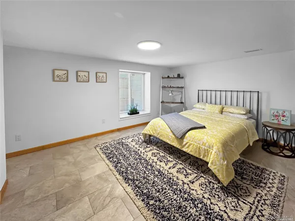 a large bed sitting in a bedroom and table