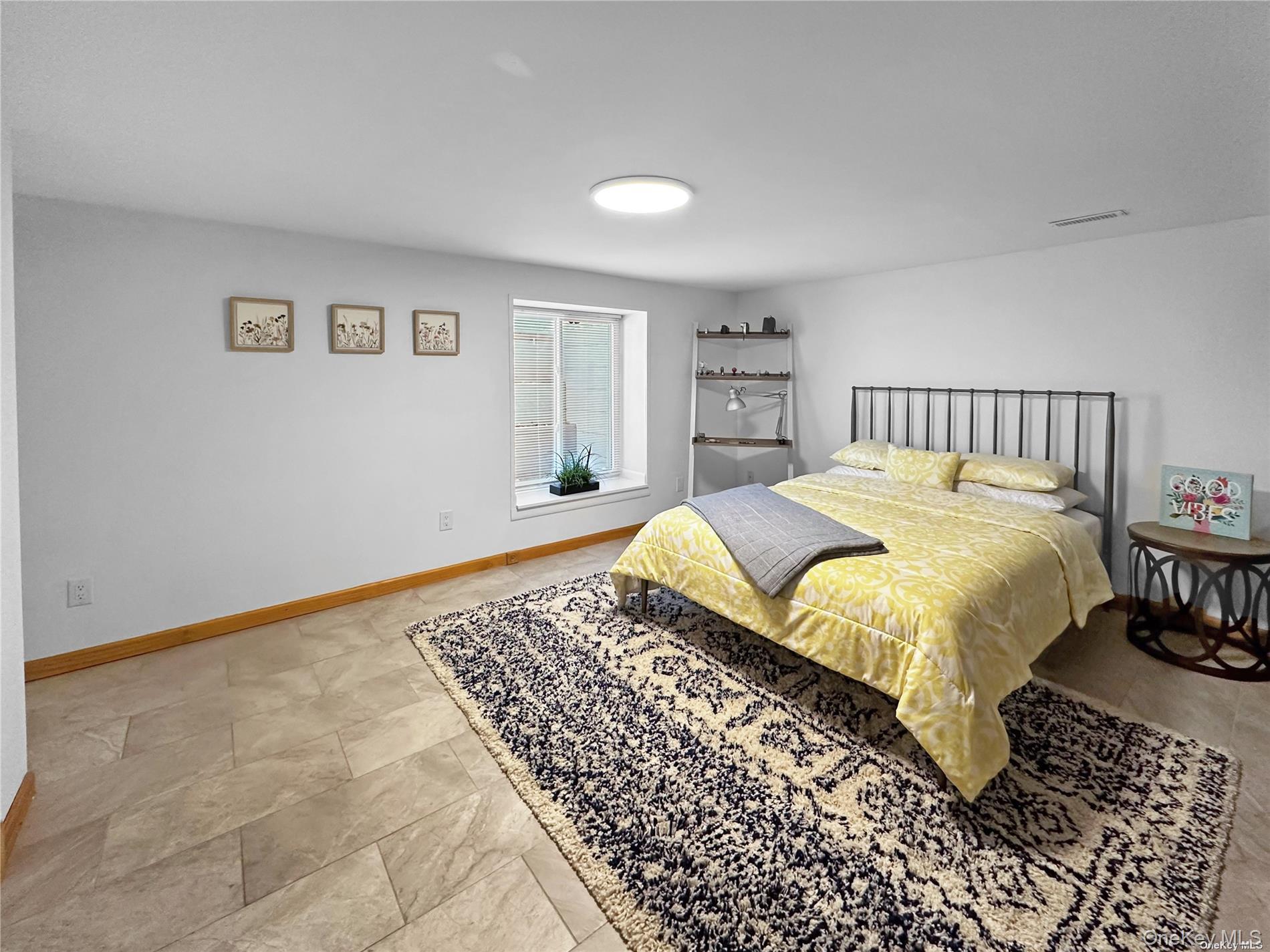 126 Overhill Road Wading River, NY 11792 - Photo 10 of 23 a large bed sitting in a bedroom and table