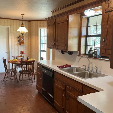 a kitchen with granite countertop a sink and cabinets
