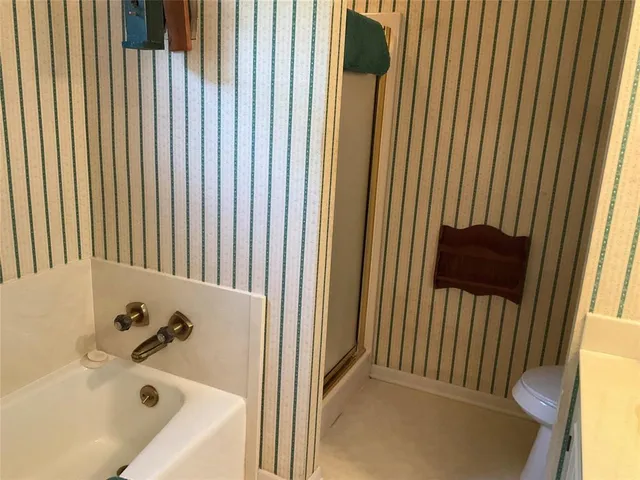 a bathroom with a bathtub and a shower