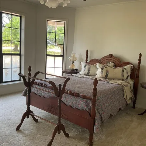 a bed room with a bed and a chair