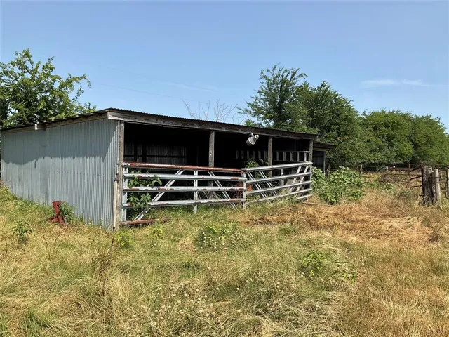 a backyard of a house with lots of green space and lake view