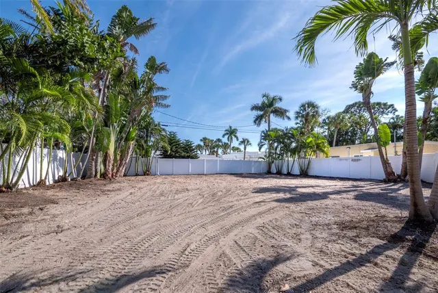 a view of yard and palm trees
