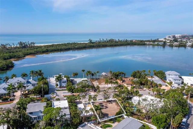 an aerial view of a houses with ocean view