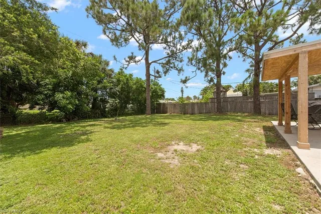 a view of yard with swimming pool and green space