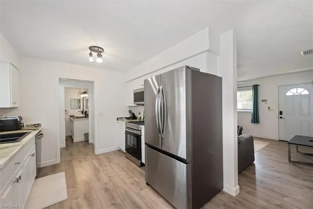 a kitchen with a refrigerator and a sink