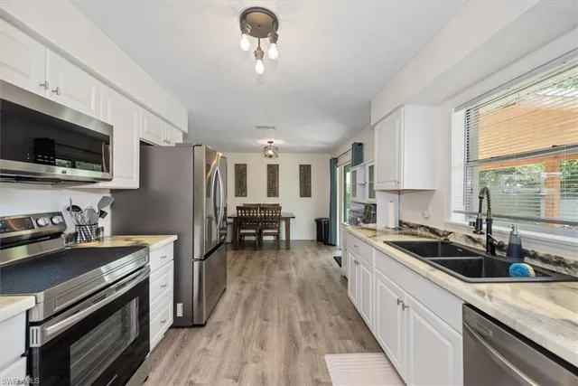 a kitchen with refrigerator a sink and stove