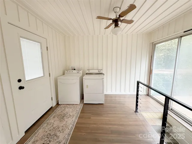 a view of a room with wooden floor and white walls