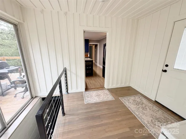 a view of entryway and hall with wooden floor