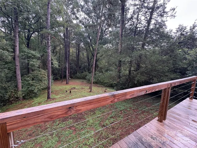 a view of a wooden deck with a yard