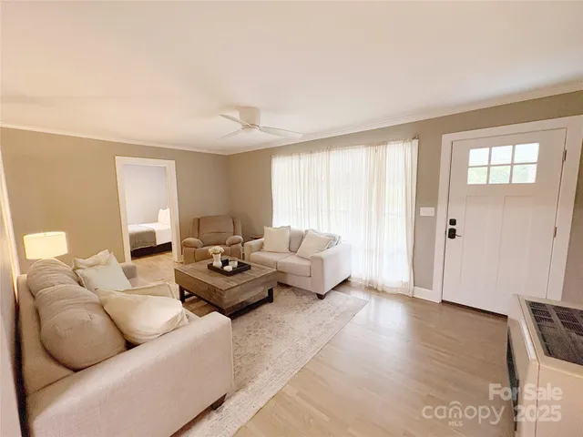 a living room with furniture and wooden floor