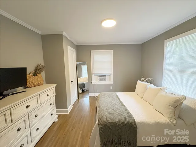 a bedroom with a bed and flat screen tv