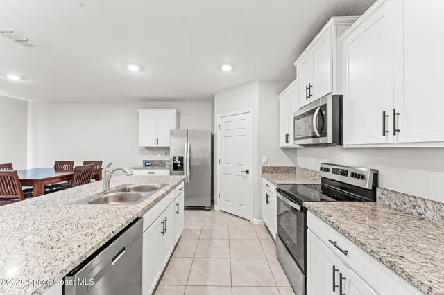 a kitchen with stainless steel appliances granite countertop a sink stove and cabinets
