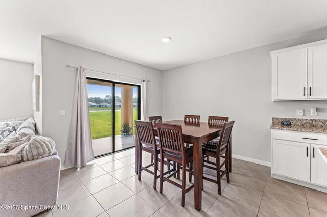 a view of a dining room with furniture window and outside view