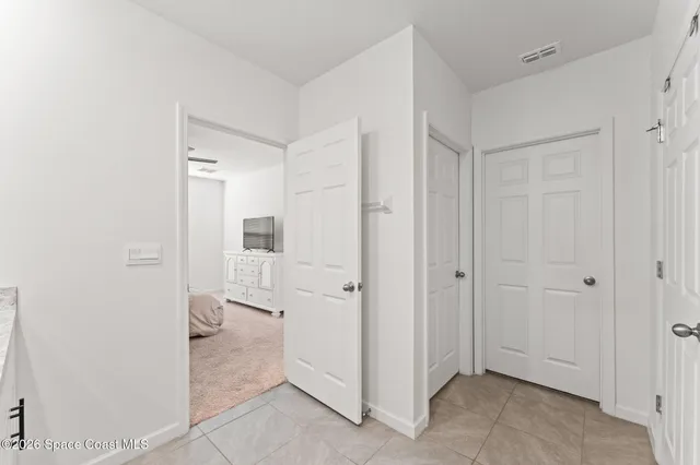 a en suite bathroom with a granite countertop sink and a mirror