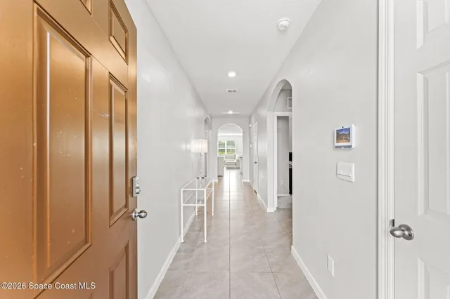 a view of a hallway with wooden shelves