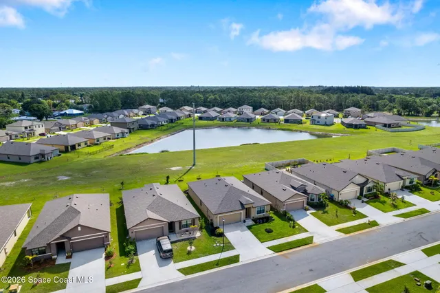 an aerial view of a house with a yard