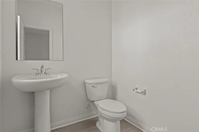 a bathroom with a sink toilet and a mirror