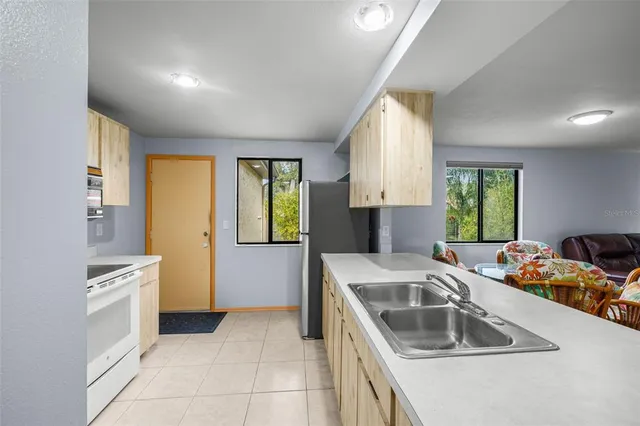 a kitchen that has a sink and a stove top oven