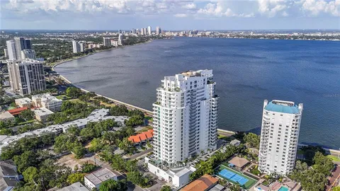 a hallway with a floor to ceiling window and potted plants
