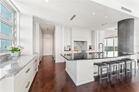 a living room with furniture flat screen tv and a large window