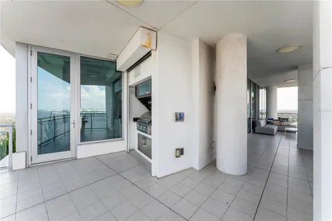 a living room with stainless steel appliances kitchen island granite countertop a sink and cabinets
