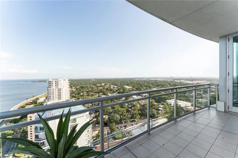 a kitchen with stainless steel appliances kitchen island granite countertop a refrigerator and a sink