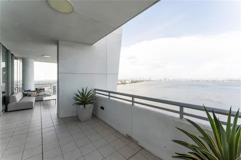 a view of a dining room with furniture a chandelier and wooden floor