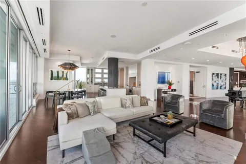 a living room with furniture and a mirror