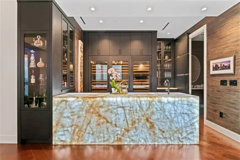 a living room with couches chairs and a coffee table with garden view