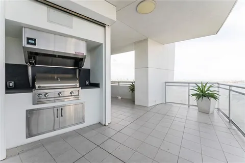 a living room with furniture and floor to ceiling window
